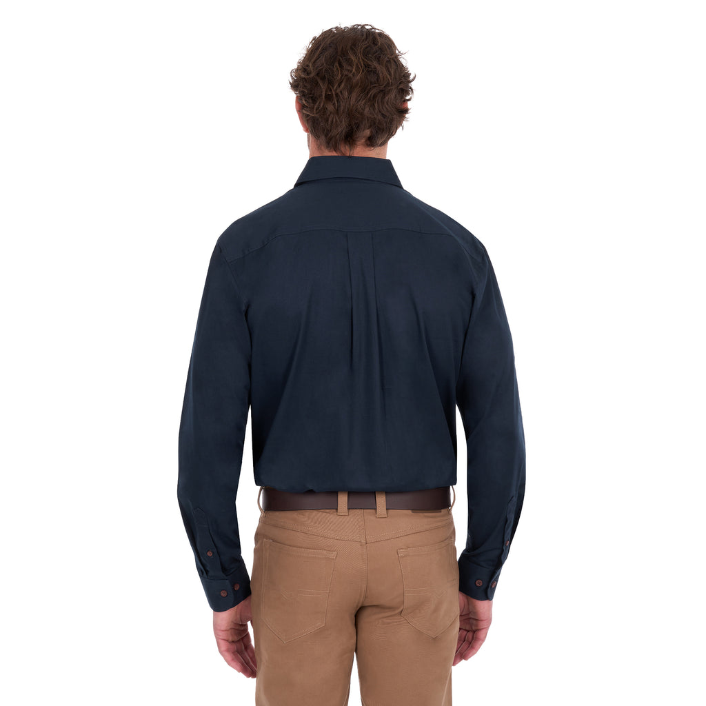 A man viewed from behind modelling a navy blue Thomas Cook Light Drill Half Button Long Sleeve Work Shirt (TCP1126005) with two chest flap pockets, paired with camel coloured jeans and a brown belt, against a plain white background.