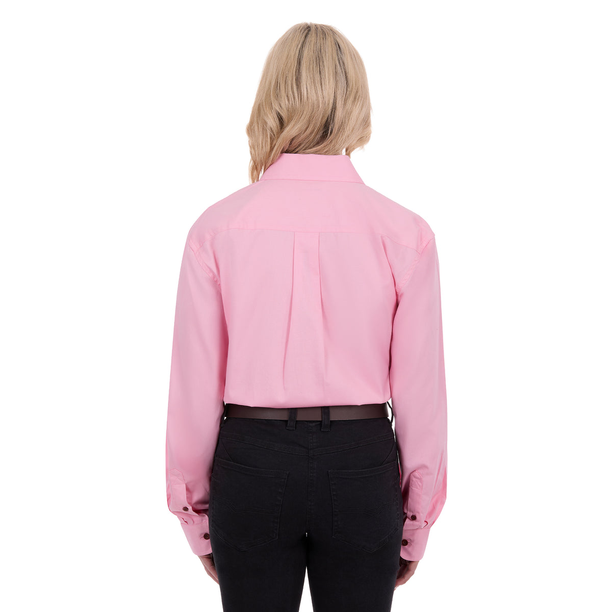 A woman viewed from behind modelling a pale pink Thomas Cook Light Drill Half Button Long Sleeve Work Shirt (TCP1126005) with two chest flap pockets, paired with black jeans and a brown belt, against a plain white background.