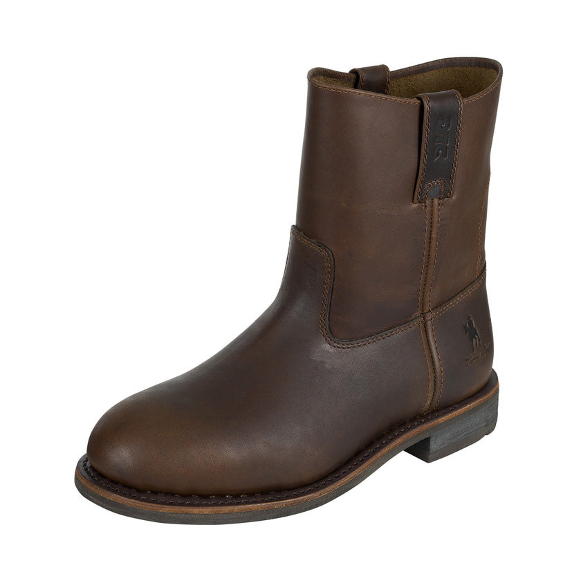 The Thomas Cook Mens Duramax DTC Trucker Boots (TCP18246) in Oily Brown are full grain leather pull-on ankle boots with a low heel, round toe, visible stitching, durable rubber sole, and an embossed horse logo near the heel.