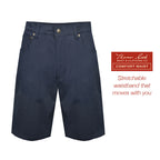 A pair of navy blue Thomas Cook Men's Jake Comfort Waist Shorts (TCP1307031) in flat lay with a branded label on the right side that reads 'Thomas Cook Boot & Clothing Co. Comfort Waist Stretchable waistband that moves with you'.