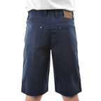 A man viewed from behind wearing dark navy blue Thomas Cook Men's Jake Comfort Waist Shorts (TCP1307031) with a white shirt partially visible at the top, photographed against a plain white studio background.