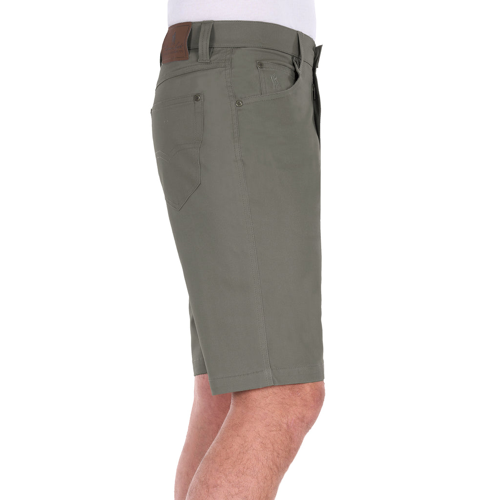 A side view of a man wearing stone Thomas Cook Men's Jake Comfort Waist Shorts (TCP1307031) with a white shirt partially visible at the top, photographed against a plain white studio background.