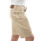 A man in profile wearing stone Thomas Cook Men's Jake Comfort Waist Shorts (TCP1307031) with a white shirt partially visible at the top, photographed against a plain white studio background.