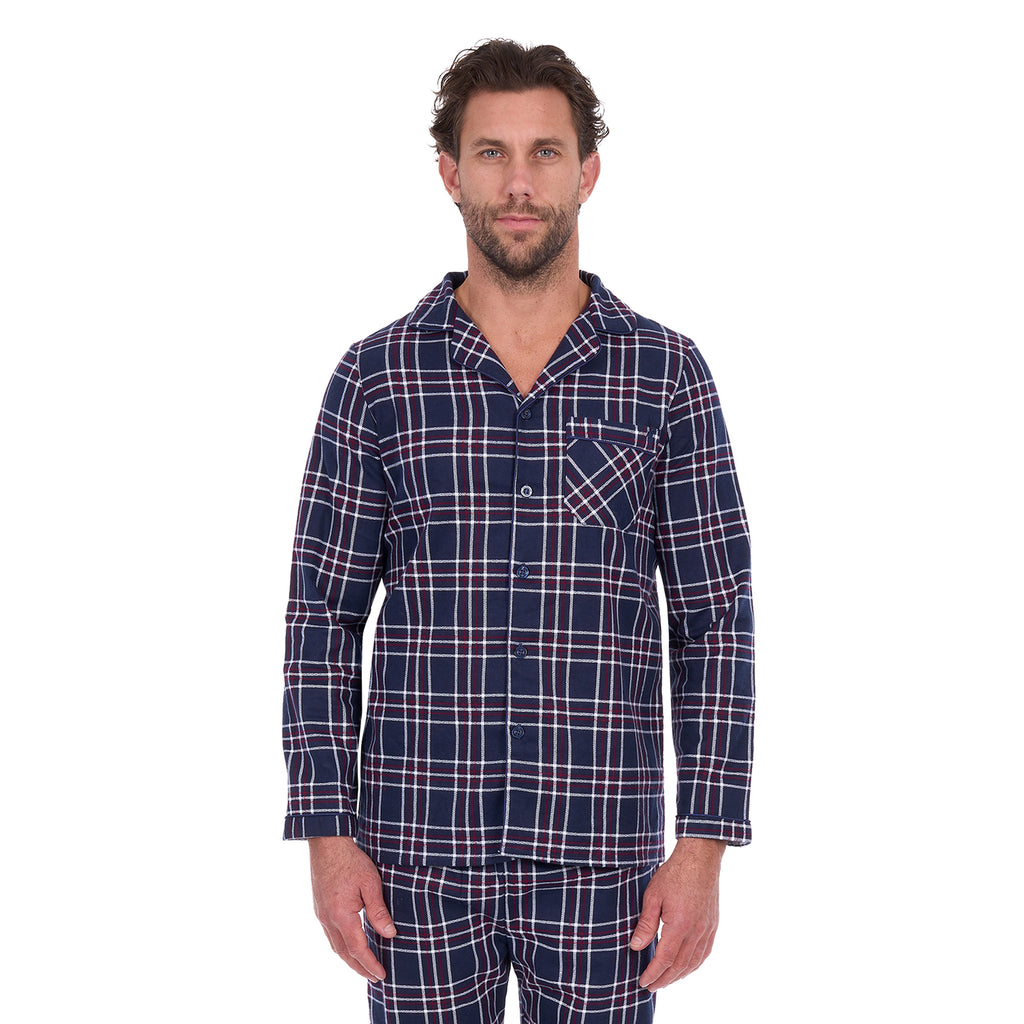 A man wearing navy blue and white plaid Thomas Cook Men's Long Sleeve Pyjamas (TCP1997PJS), standing against a solid white background.