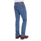 A man shown from the waist down, modelling a pair light blue Thomas Cook Men's Lochie Tailored Jeans (TCP1226064) paired with brown boots on a white background.