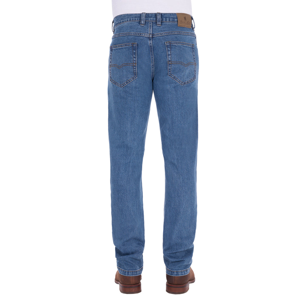 A man shown from the waist down, from behind, modelling a pair light blue Thomas Cook Men's Lochie Tailored Jeans (TCP1226064) paired with brown boots on a white background.