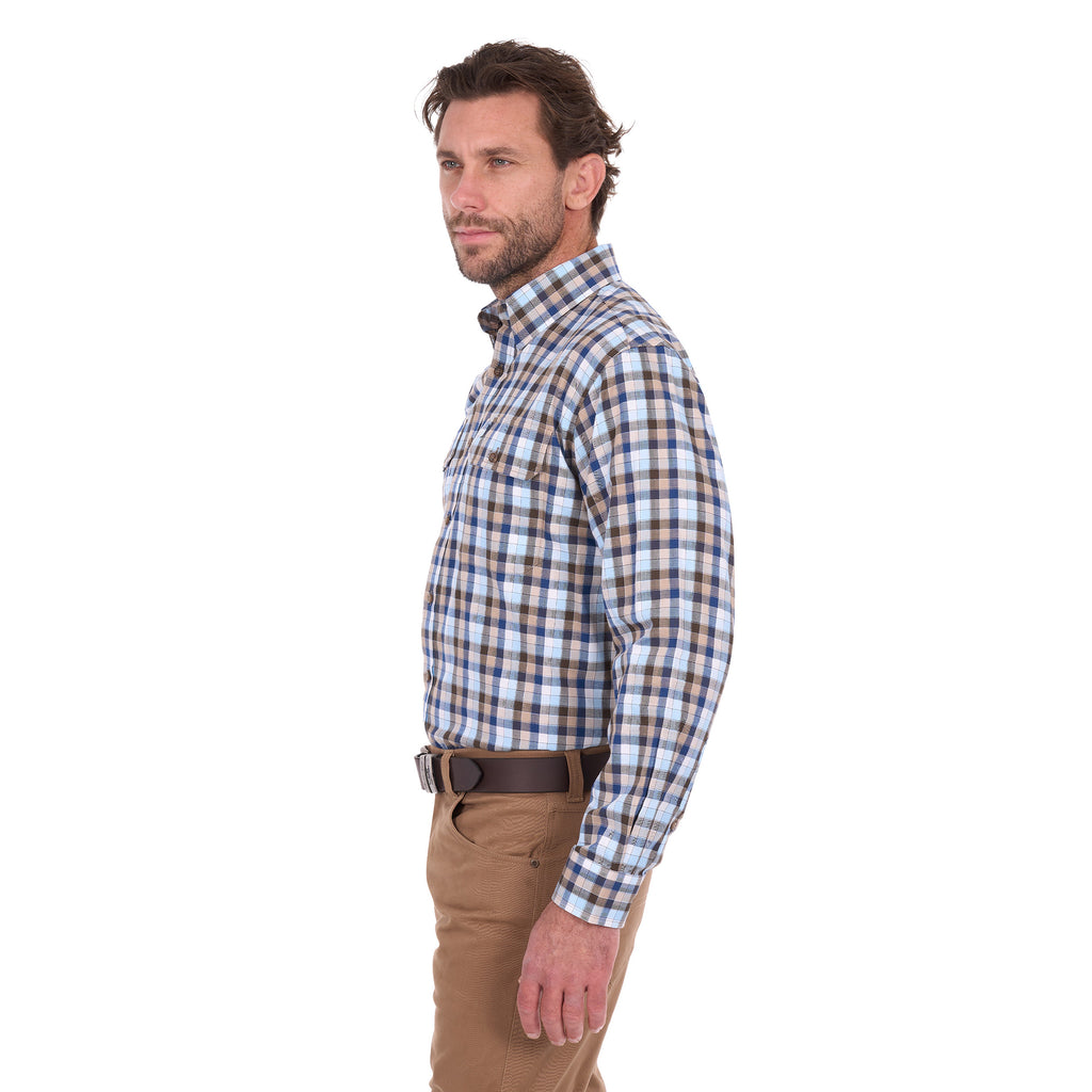 A man in profile modelling a navy, tan, blue and white Thomas Cook Men's Mitchell Long Sleeve Shirt (TCP1115100) paired with a brown belt and camel coloured jeans on a white background.