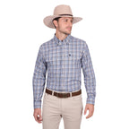 A man wearing the Thomas Cook Mens Patrick L/S Shirt (T6W1115035) Blue/Tan stands against a plain white background, paired with a light beige cowboy hat, brown belt, and beige pants, looking to his left.