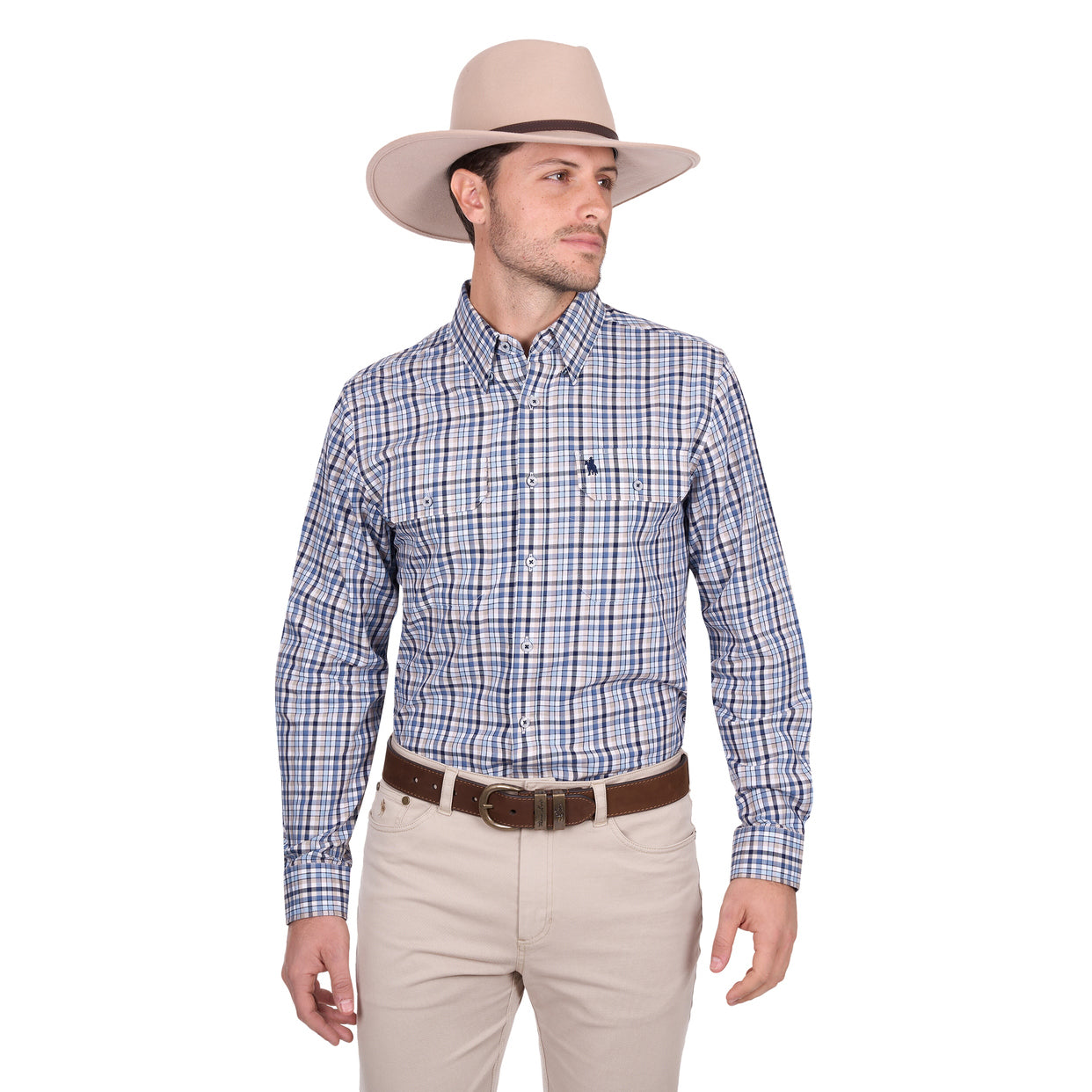 A man wearing the Thomas Cook Mens Patrick L/S Shirt (T6W1115035) Blue/Tan stands against a plain white background, paired with a light beige cowboy hat, brown belt, and beige pants, looking to his left.