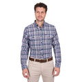 A man stands facing forward in a Thomas Cook Mens Sean L/S Shirt (T6W1115032) Blue/Red, paired with beige pants and a brown belt, against a white background.