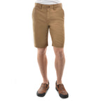 A man shown from the waist down modelling a pair of bone Thomas Cook Men's Tailored Fit Mossman Comfort Waist Shorts (TCP1306091) with belt loops, a button closure, and front pockets, shown against a plain white background.