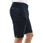 A side view of a pair of dark navy  Thomas Cook Men's Tailored Fit Mossman Comfort Waist Shorts (TCP1306091) with belt loops, a button closure, front slant pockets and back jet pockets, against a plain white background.