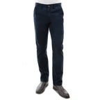 A man from the waist down wearing a pair of dark navy Thomas Cook Men's Tailored Fit Mossman Comfort Waist Trousers (TCP1209091) with a pair of brown boots on a white studio background.