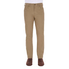 A man from the waist down modelling a pair of sand coloured Thomas Cook Men's Tailored Moleskin Jeans 30" Leg (TCP1206007) paired with a white tee and brown boots.