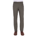 A man modelling a pair of greystone Thomas Cook Men's Tailored Mossman Trousers (TCP1209091) paired with a white tee and brown boots on a white background.
