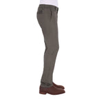 A man in profile modelling a pair of greystone Thomas Cook Men's Tailored Mossman Trousers (TCP1209091) paired with a white tee and brown boots on a white background.
