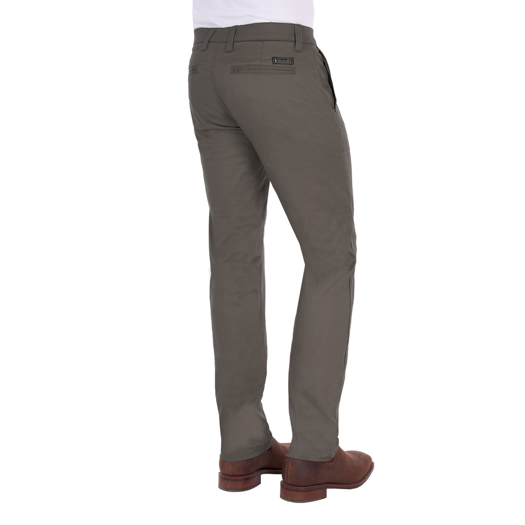 A man from a 3-4 back view modelling a pair of greystone Thomas Cook Men's Tailored Mossman Trousers (TCP1209091) paired with a white tee and brown boots on a white background.