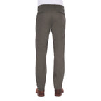 A man viewed from behind modelling a pair of greystone Thomas Cook Men's Tailored Mossman Trousers (TCP1209091) paired with a white tee and brown boots on a white background.