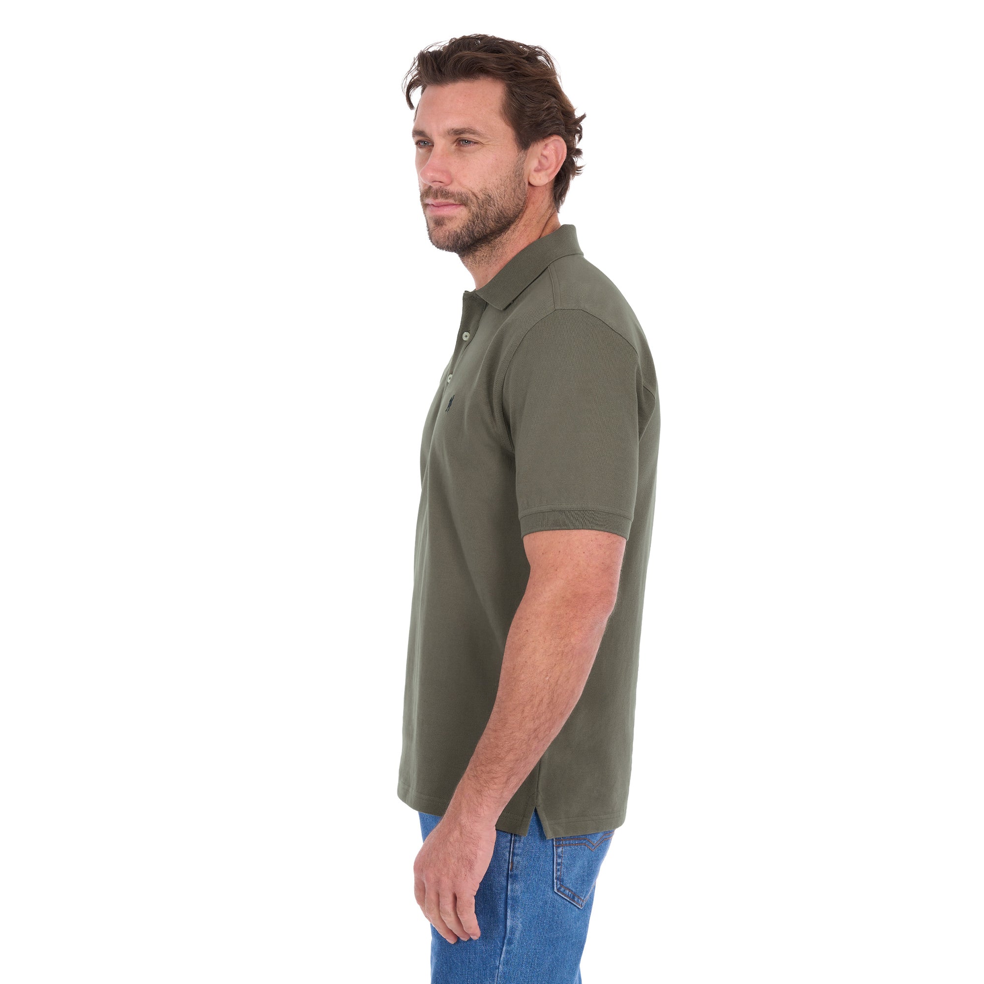 A man in profile modelling a military green Thomas Cook Men's Tailored Short Sleeve Polo (TCP1506009) paired with blue denim jeans on a white background.