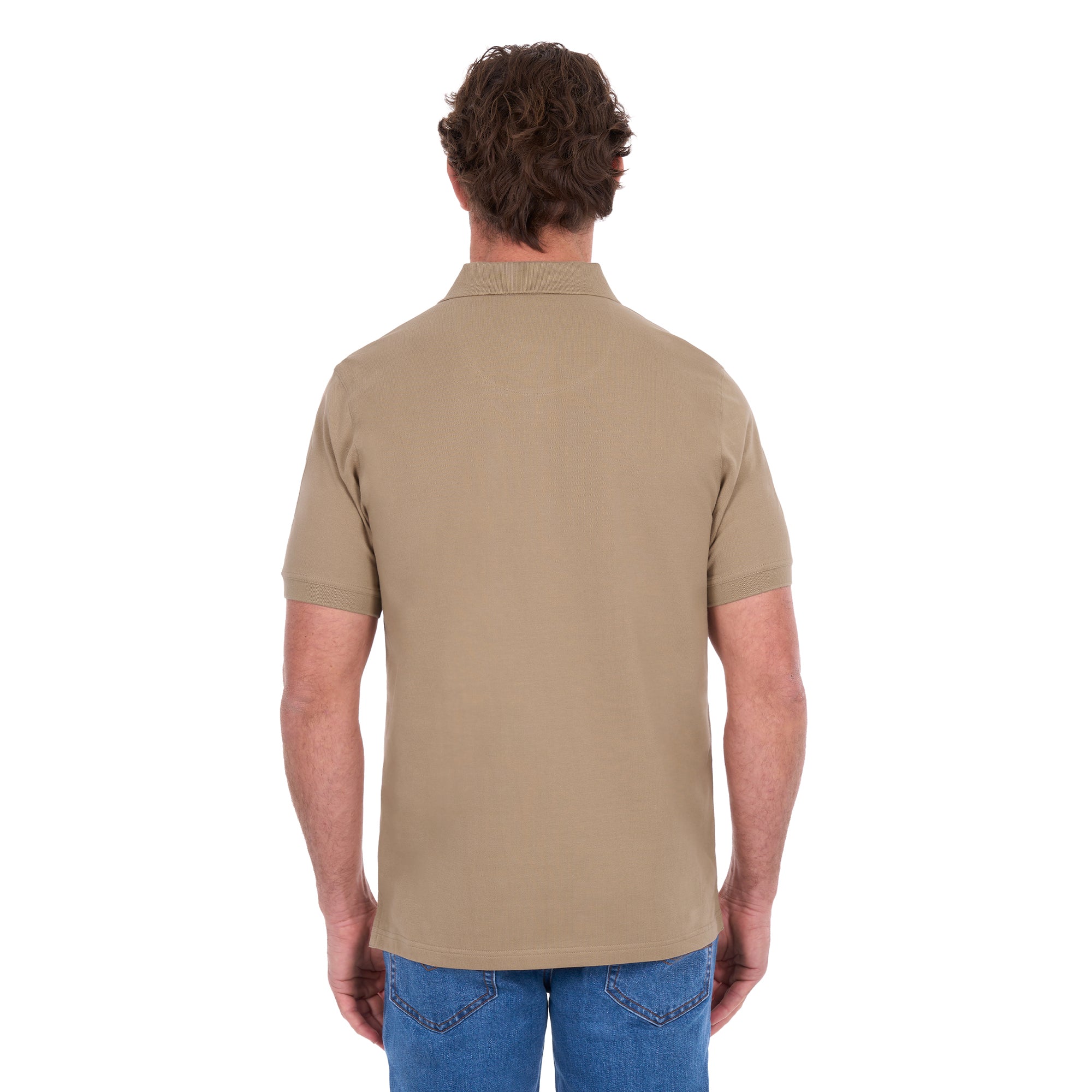 A man shown from behind, modelling a sand coloured Thomas Cook Men's Tailored Short Sleeve Polo (TCP1506009) paired with blue denim jeans on a white background.