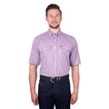 A man wearing a royal blue, white and red Thomas Cook Men's Wentworth Short Sleeve Dress Shirt (TCP1110158) with two chest pockets, paired with dark blue jeans and a black belt, against a plain white background.