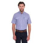 A man modelling a navy blue and white Thomas Cook Men's Wentworth Short Sleeve Check Shirt (TCP1110158) with navy blue pants and a brown belt.