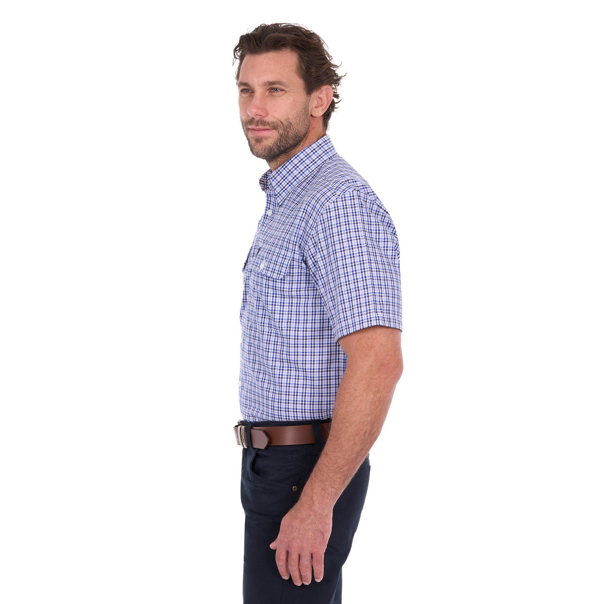 A man in profile modelling a navy blue and white Thomas Cook Men's Wentworth Short Sleeve Check Shirt (TCP1110158) with navy blue pants and a brown belt.