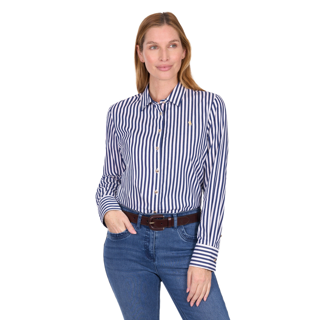 A woman stands against a white background wearing the Thomas Cook Womens Celine L/S Shirt (T6W2130085) in Navy/White, blue jeans, and a brown belt. She has one hand in her pocket and is smiling slightly.