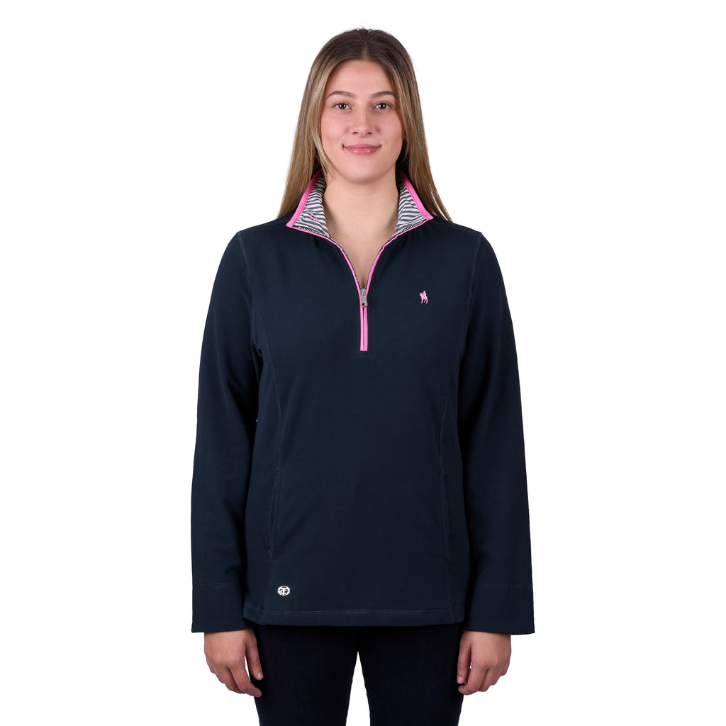 A woman modelling a navy blue Thomas Cook Women's Charlie Classic 1/4 Zip Neck Rugby (TCP2511030) with a pink zipper and a pink, white, and blue striped inner collar, shown against a plain white background.