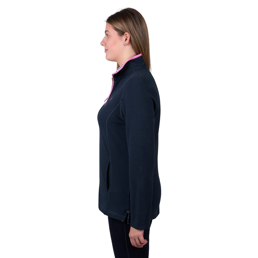 A woman in profile modelling a navy blue Thomas Cook Women's Charlie Classic 1/4 Zip Neck Rugby (TCP2511030) with a pink zipper and a pink, white, and blue striped inner collar, shown against a plain white background.
