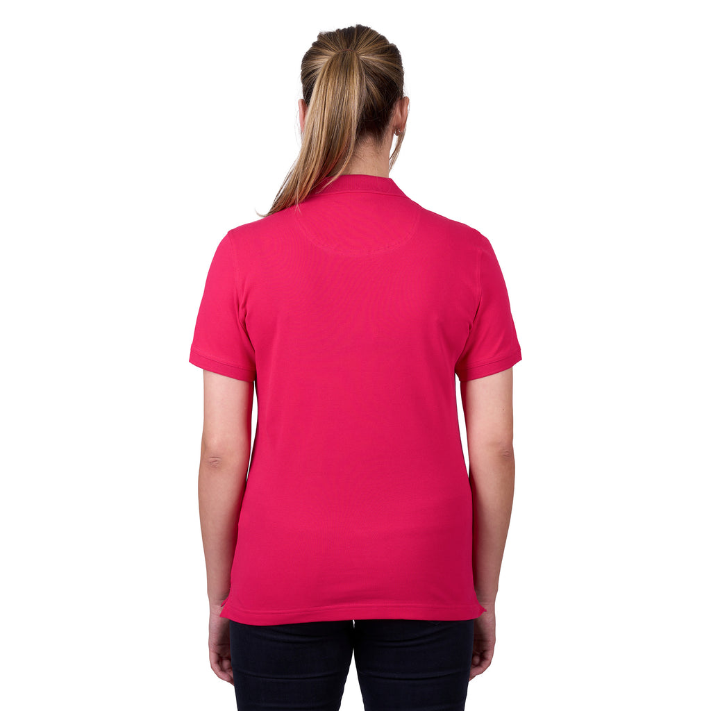 A woman modelling a bright rose coloured Thomas Cook Women's Classic Stretch Short Sleeve Polo Shirt (TCP2512059), set against a plain white background.