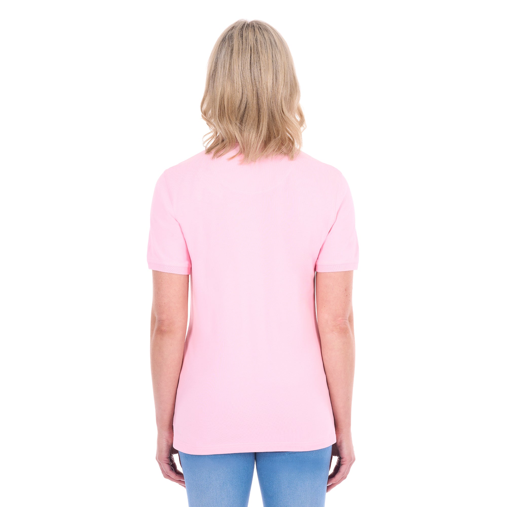 A woman modelling a light pink Thomas Cook Women's Classic Stretch Short Sleeve Polo (TCP2512059) and blue jeans, shown from behind against a plain white background.