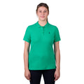 A woman wearing a peppermint green Thomas Cook Women's Classic Stretch Short Sleeve Polo with a Thomas Cook embroidered logo on a white background.
