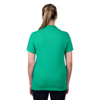 A woman viewed from behind wearing a peppermint green Thomas Cook Women's Classic Stretch Short Sleeve Polo on a white background.