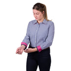 A woman modelling a Thomas Cook Women's Lawson Long Sleeve Shirt (TCP2112178) with vertical blue and white stripes and bright pink rolled cuffs, paired with dark pants and a brown belt, against a plain white background.