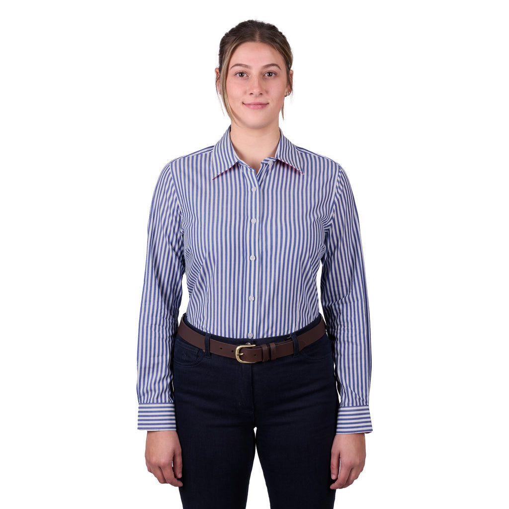 A woman modelling a Thomas Cook Women's Lawson Long Sleeve Shirt (TCP2112178) with vertical blue and white stripes, paired with dark pants and a brown belt, against a plain white background.
