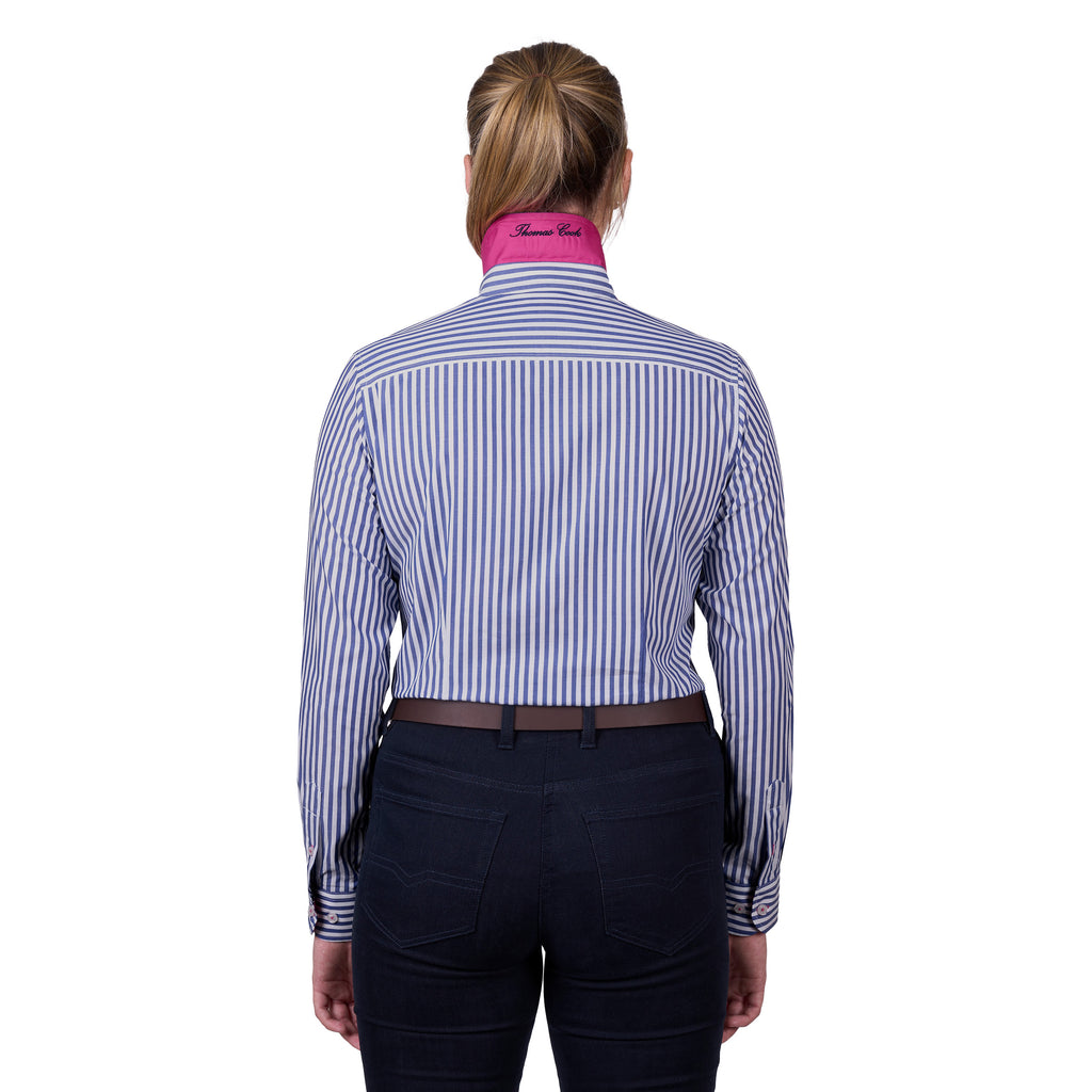 A woman viewed from the back wearing a blue and white vertically striped Thomas Cook Women's Lawson Long Sleeve Shirt (TCP2112178) with a bright pink under collar, paired with dark navy pants and a brown belt, against a plain white background.