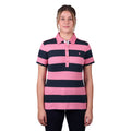 A woman modelling a dark navy and soft pink Thomas Cook Women's Rachel Stripe Polo (TCP2501053) paired with dark pants on a white studio background.
