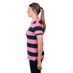 A woman in profile modelling a dark navy and soft pink Thomas Cook Women's Rachel Stripe Polo (TCP2501053) paired with dark pants on a white studio background.