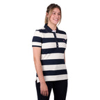 A woman modelling a dark navy and white Thomas Cook Women's Rachel Stripe Polo (TCP2501053) paired with dark pants on a white studio background.