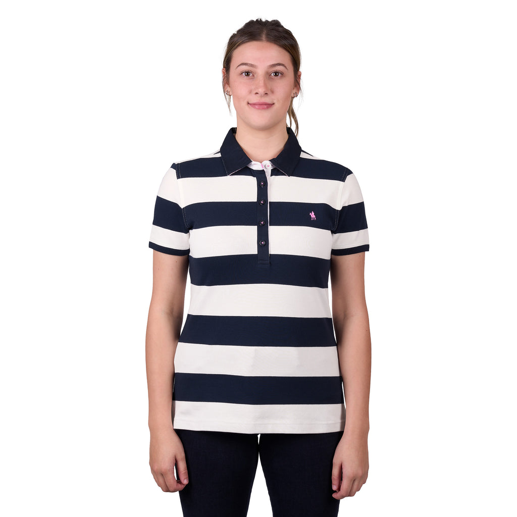 A woman modelling a dark navy and white Thomas Cook Women's Rachel Stripe Polo (TCP2501053) paired with dark pants on a white studio background.