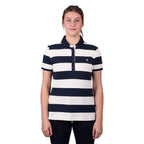 A woman modelling a dark navy and white Thomas Cook Women's Rachel Stripe Polo (TCP2501053) paired with dark pants on a white studio background.