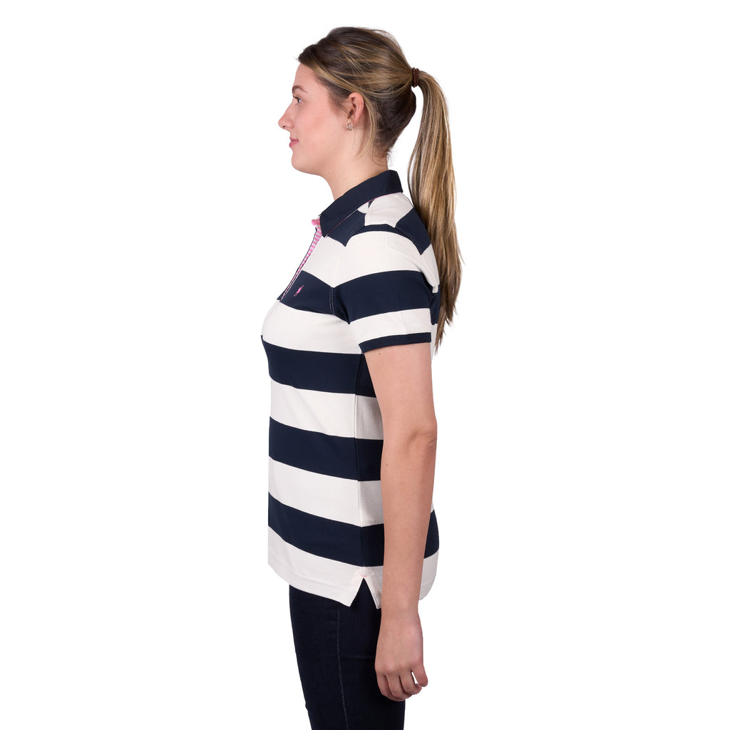 A woman in profile modelling a dark navy and white Thomas Cook Women's Rachel Stripe Polo (TCP2501053) paired with dark pants on a white studio background.