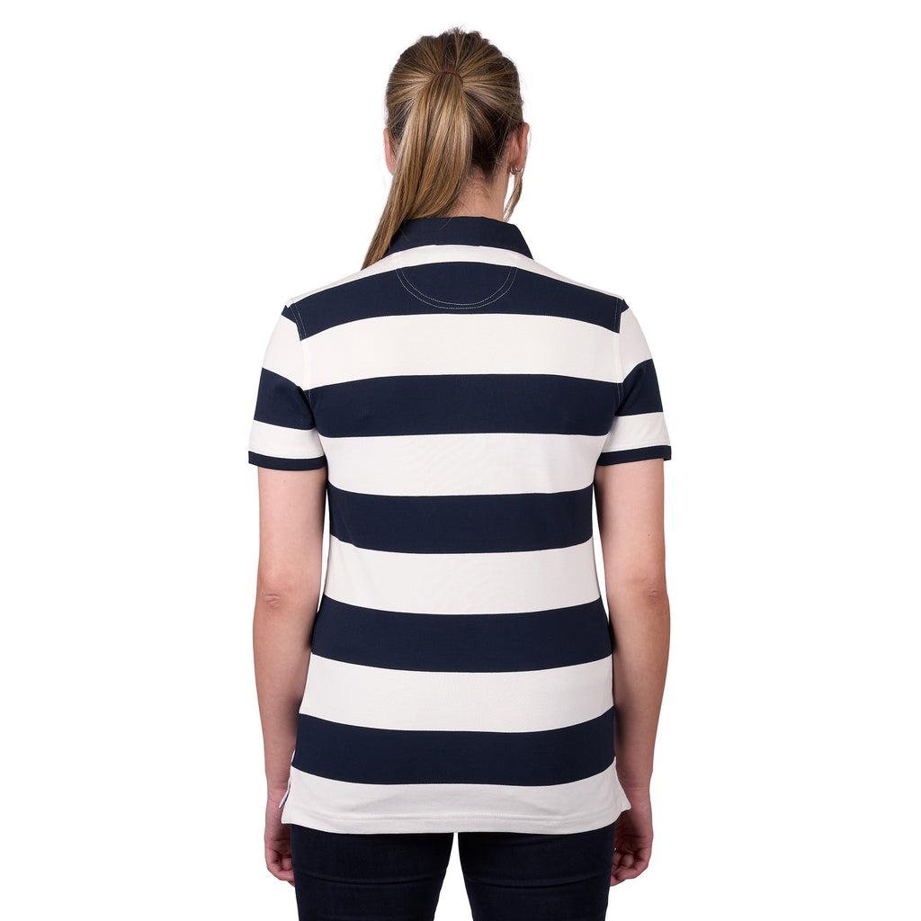 A woman viewed from behind, modelling a dark navy and white Thomas Cook Women's Rachel Stripe Polo (TCP2501053) paired with dark pants on a white studio background.