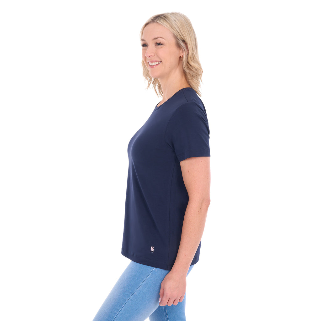 A woman in profile modelling a navy blue Thomas Cook Women's Round Neck Short Sleeve Tee (TCP2515104) paired with blue denim jeans on a white background.