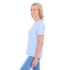 A woman viewed in profile modelling a pale blue Thomas Cook Women's Round Neck Short Sleeve Tee (TCP2515104) paired with blue denim jeans on a white background.