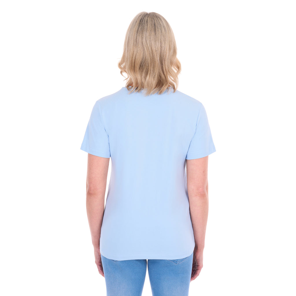 A woman shown from behind modelling a pale blue Thomas Cook Women's Round Neck Short Sleeve Tee (TCP2515104) paired with blue denim jeans on a white background.