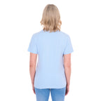 A woman shown from behind modelling a pale blue Thomas Cook Women's Round Neck Short Sleeve Tee (TCP2515104) paired with blue denim jeans on a white background.