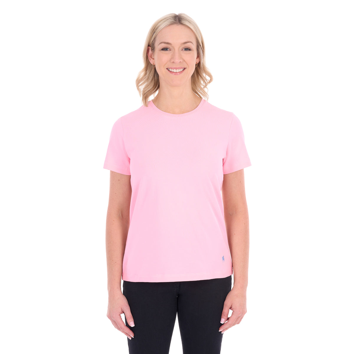 A woman modelling a rose pink Thomas Cook Women's Round Neck Short Sleeve Tee (TCP2515104) paired with blue denim jeans on a white background.