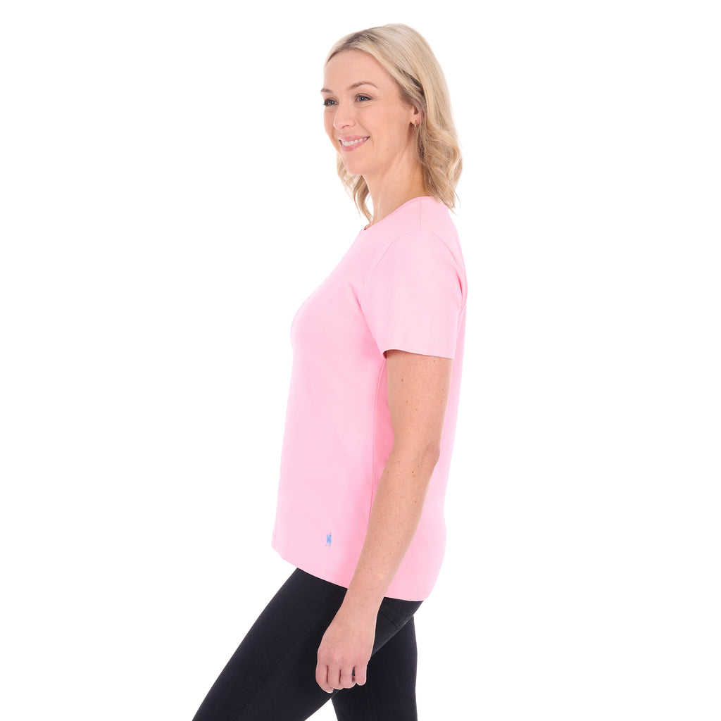 A woman in profile modelling a rose pink Thomas Cook Women's Round Neck Short Sleeve Tee (TCP2515104) paired with blue denim jeans on a white background.
